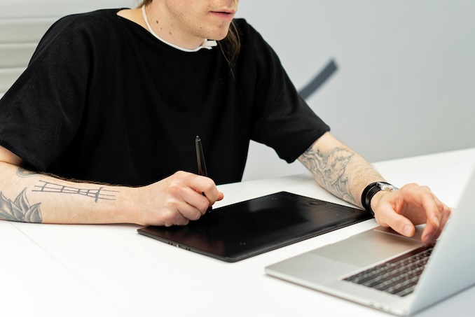 Person using a computer at a desk.