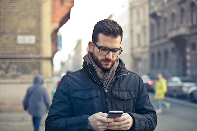 Guy using his cell phone in the street.