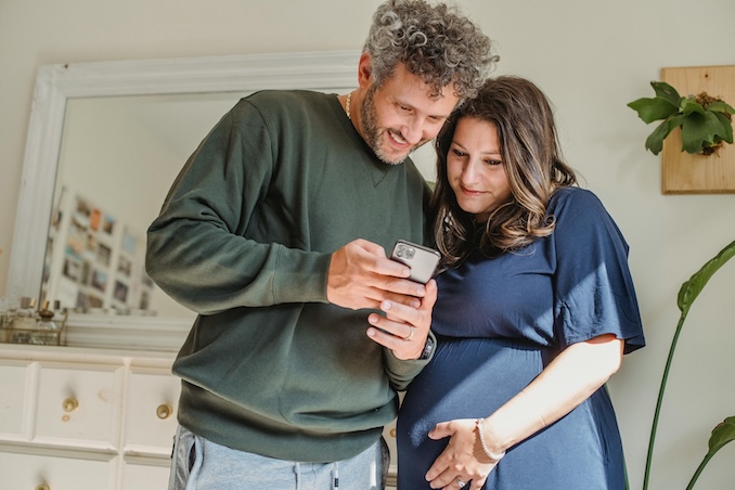 Couple looking at their cell phone together.