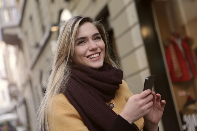 Woman on her smart phone outside.