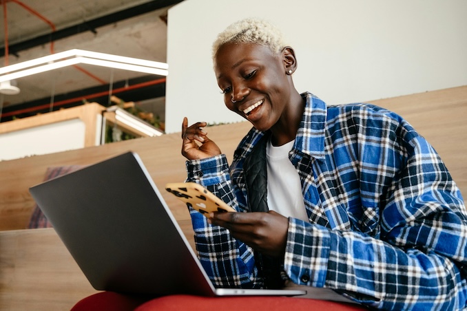Woman laughing at cell phone